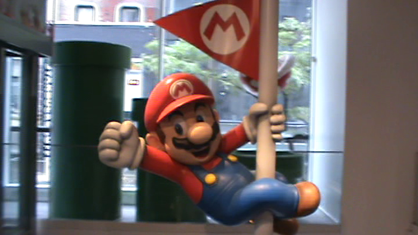 Mario statue on a flagpole